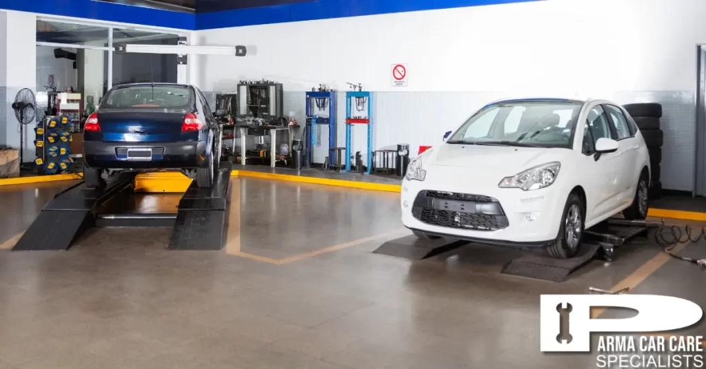 Cars undergoing maintenance in modern auto service garage. | PCC