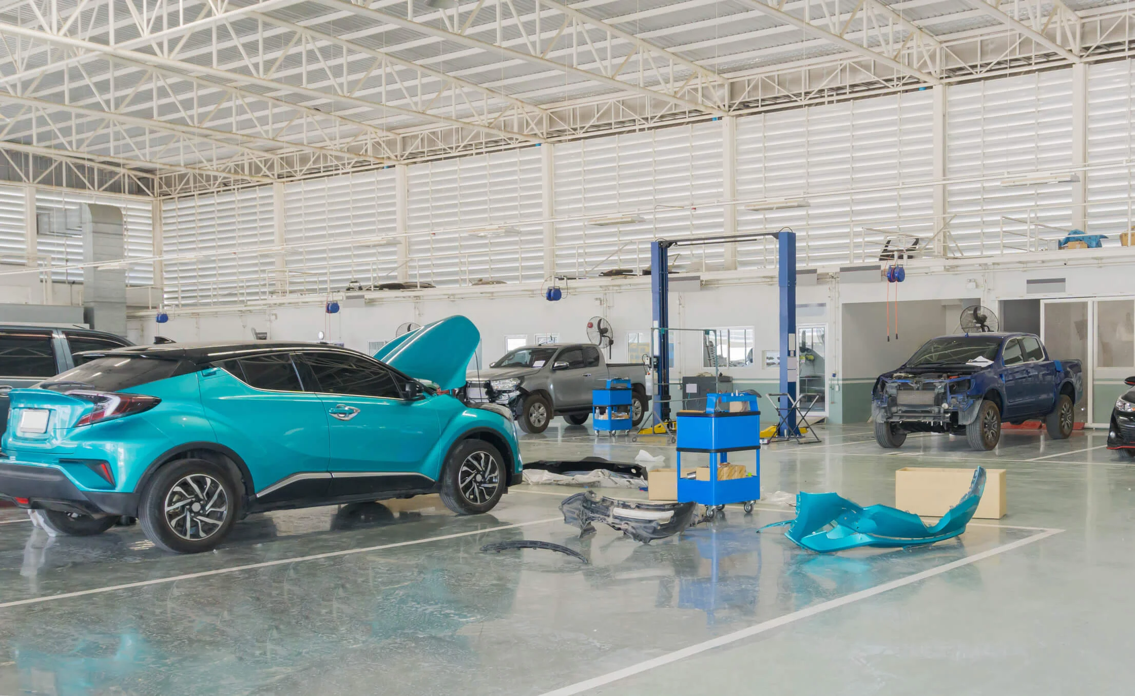 An auto repair facility with cars being repaired and maintained.