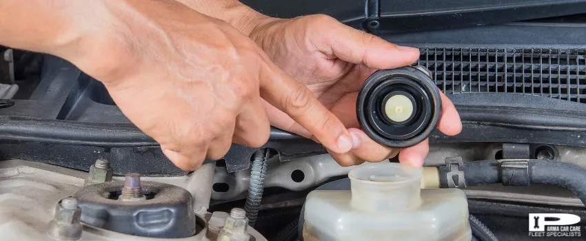 PCC - A driver checking his car's brake fluid inlet